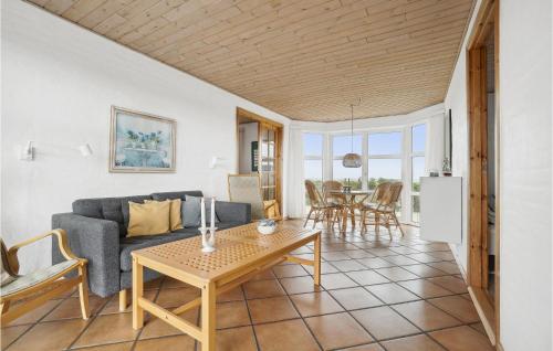 a living room with a couch and a table at 4 Bedroom Stunning Home In Thisted in Thisted