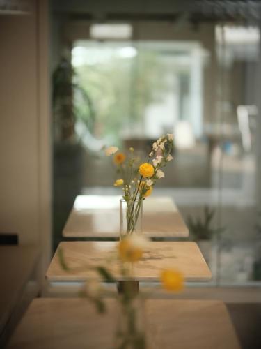 a vase of flowers sitting on a table at Guilin Bonjour Boutique Hotel- Free pick up service over 3 nights in Guilin