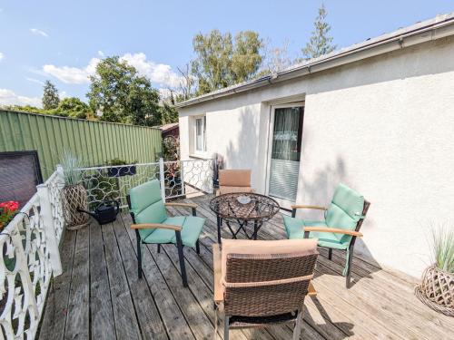 a patio with chairs and a table on a deck at Ferienhaus Plauer Oase in Plau am See
