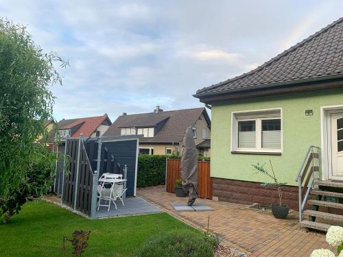 a backyard of a house with a deck with a table at Ferienwohnung Inge in Malchow