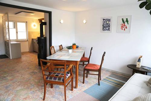 a dining room with a table and some chairs at Ferienhaus Blaues Häuschen in Freudenberg am Main