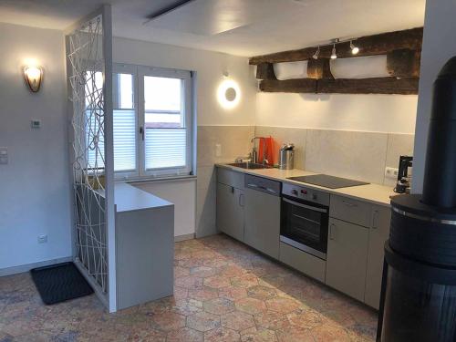 a kitchen with a sink and a stove top oven at Ferienhaus Blaues Häuschen in Freudenberg am Main