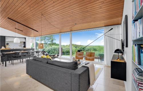 a living room with a couch and a dining room at Four-Bedroom Holiday Home In Lundby in Lundby