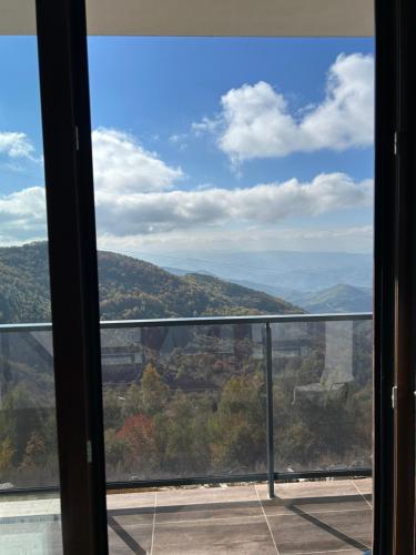 a view of the blue mountains from a window at Apartman Magdalena Kopaonik in Cajetina