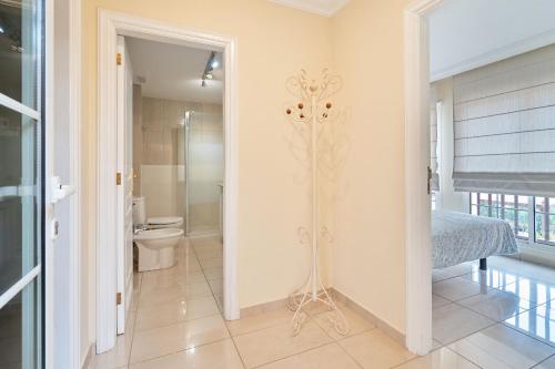 a bathroom with a shower and a toilet in a room at Terrazas del Duque Beach Apartment in Adeje