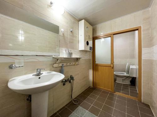 a bathroom with a sink and a toilet at Pyeongchang The Meomum Pension in Pyeongchang 