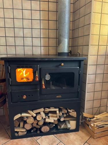 a stove with a fire inside of it at Casetta Zoe in Margone