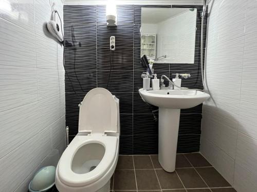 a small bathroom with a toilet and a sink at Pyeongchang The Meomum Pension in Pyeongchang 