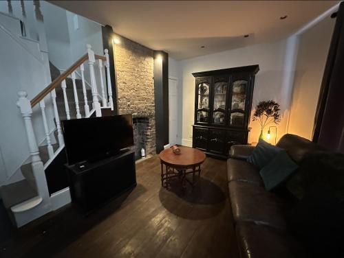 a living room with a couch and a table at Central Margate house with sauna & private garden in Kent