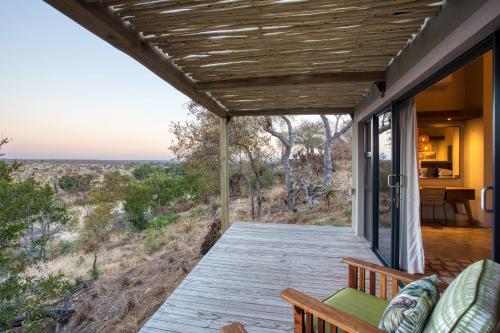a porch with a view of the desert at Klaserie Drift Misava in Klaserie Private Nature Reserve