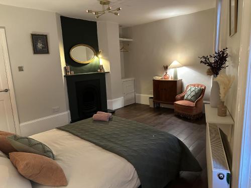 a bedroom with a bed with a fireplace and a mirror at Central Margate house with sauna & private garden in Kent
