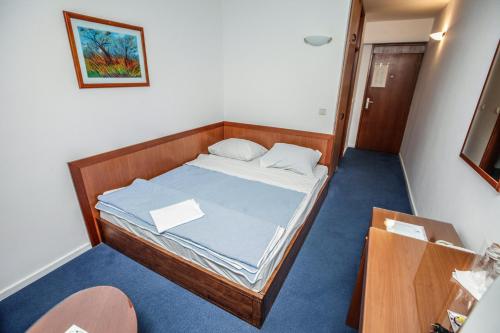 a small bedroom with a bed in a room at Hotel Saraj in Sarajevo