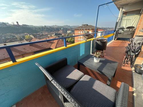 a balcony with a table and chairs on a roof at Affordable 3 roms appartment with special price summer 2025 in Dogliani