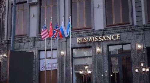 a building with three american flags in front of it at Renaissance Boutique Hotel in Samarkand