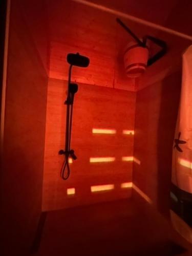 a room with a light on the wall and a spotlight at A villa in nature in Sindietʼi