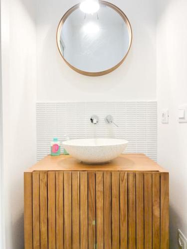 a bathroom with a white sink and a mirror at Civico 21 living - Tuscan loft in Fucecchio