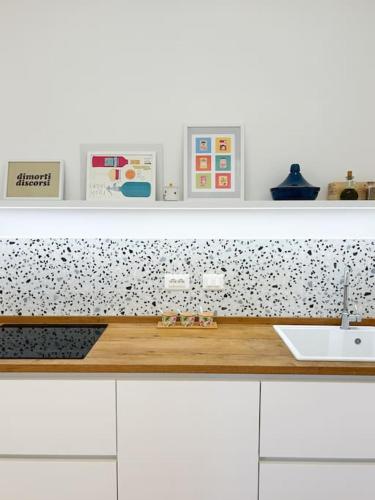 a kitchen with a counter top with a sink at Civico 21 living - Tuscan loft in Fucecchio