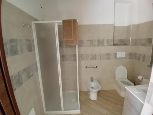 a white bathroom with a toilet and a sink at Casa vacanza P&G in Laino Castello