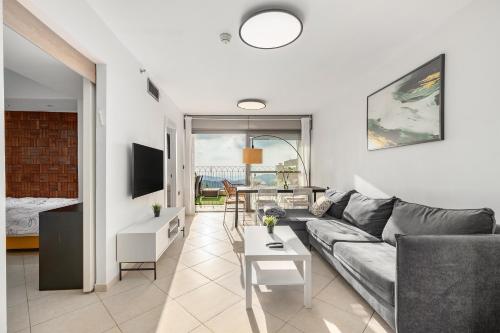 a living room with a couch and a table at pisgat shoresh in Shoresh