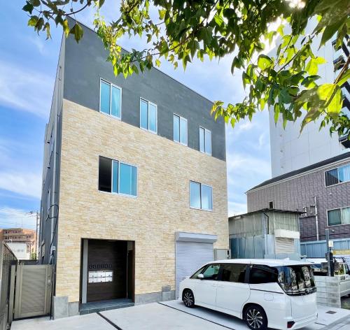 a white van parked in front of a building at 君の家AOTO#Haneda&Narita Access#Free reserved parking in Tokyo