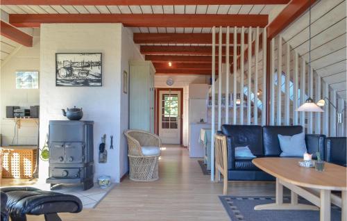 a living room with a couch and a table at Holiday Home Tingodden Iv in Hvide Sande