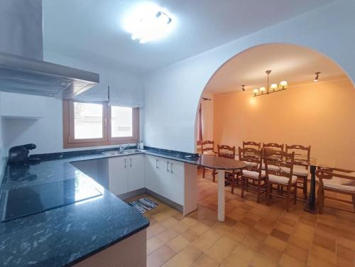 a kitchen with a table and a dining room at Casa Rural en Valmuel El Arquero in Valmuel