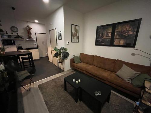 a living room with a couch and a table at Studio E in Purmerend