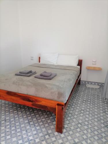 a bedroom with a bed with two towels on it at Baan KaemSai in Khao Lak