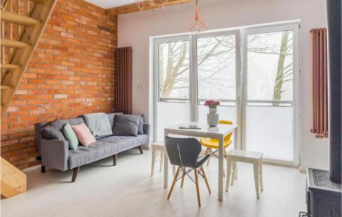 a living room with a couch and a table at Lovely Home In Taszów With Sauna in Taszów
