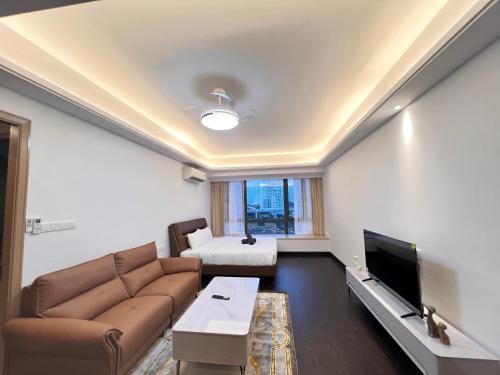a living room with a couch and a tv at R&F Princess Cove View Residences by WSD in Johor Bahru