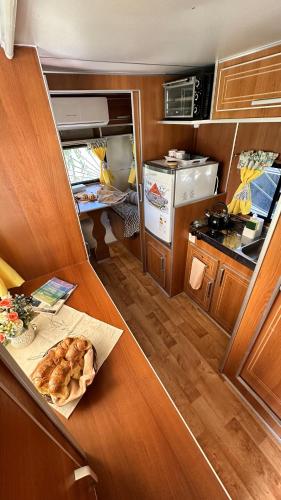a kitchen with a table with a food on it at Playa & Campo - Experiencia Glamping en Mar de Ajó in Mar de Ajó
