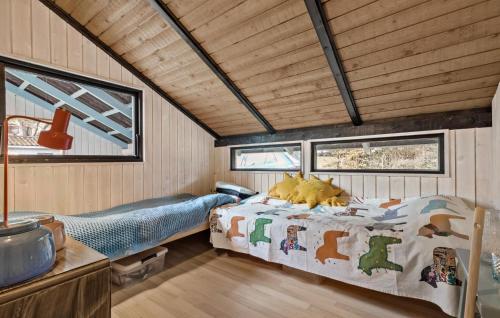 a bedroom in a tiny house with a bed at Stunning Home In Rønde With Wifi in Rønde