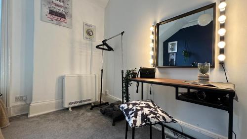 a room with a table with a mirror on the wall at Flat for 6 guests near Glasgow, Loch Lomond in Dumbarton