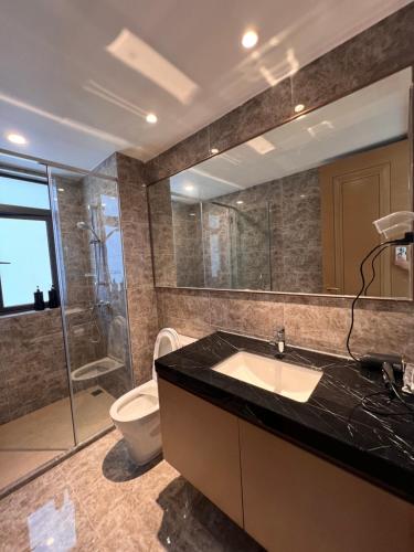 a bathroom with a sink and a shower and a toilet at R&F Princess Cove View Residences by WSD in Johor Bahru