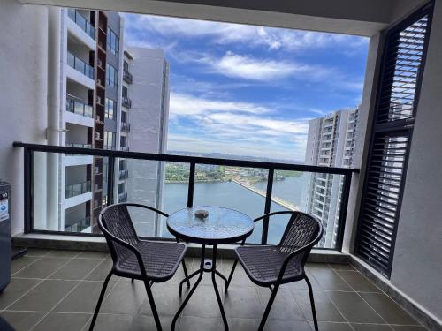 a balcony with a table and chairs and a view of the water at R&F Princess Cove View Residences by WSD in Johor Bahru