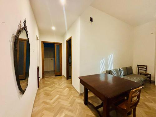 a dining room with a table and a couch at La Bottaia de' Roveri in Ortona