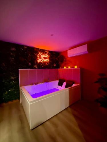 a hot tub with purple lighting in a room at Suite LIANA - SPA- SAUNA in Rorschwihr