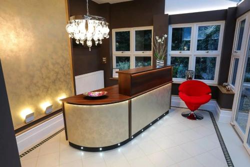 a office with a red chair and a desk at Derby Manor in Bournemouth