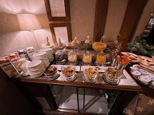 a table with a bunch of food on it at Le Samovar Guest House in Breuil-Cervinia