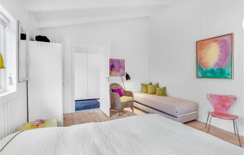 a white bedroom with a bed and a couch at Nice Home In Fårevejle With Kitchen in Fårevejle