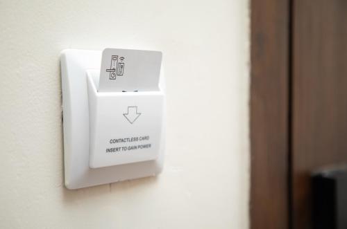 a lightswitch on a wall next to a door at The Madras Grand in Chennai
