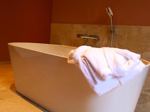 a towel sitting on the side of a bath tub at Domaine du cloitre in Pléneuf-Val-André