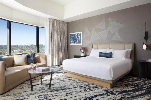 a hotel room with a bed and a couch at InterContinental Seattle Bellevue, by IHG in Bellevue