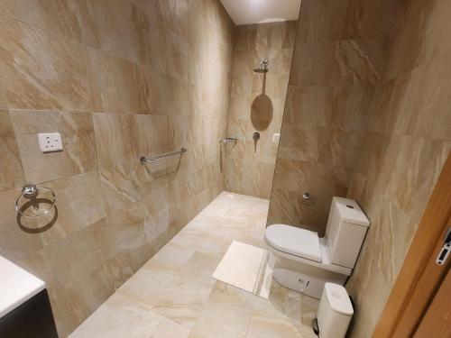 a bathroom with a toilet and a shower at Stunning 2 Bedroom App at Relax Complex in Bijilo