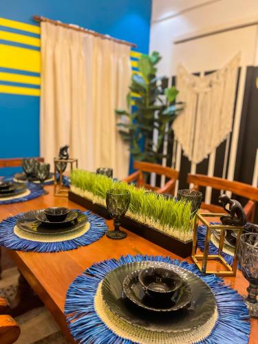 a wooden table with plates on top of it at UNWND Boutique Hotel Calatagan in Batangas City