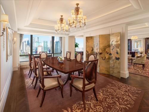 a dining room with a table and chairs at Waldorf Astoria Shanghai on the Bund in Shanghai