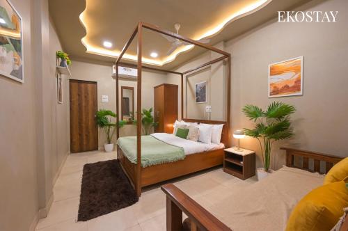 a hotel room with a bed and a mirror at EKOSTAY Gold - Driftwood Villa in Alibaug