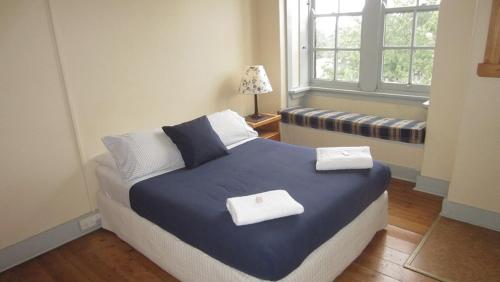 a bedroom with a bed with two towels on it at Katoomba Mountain Lodge in Katoomba