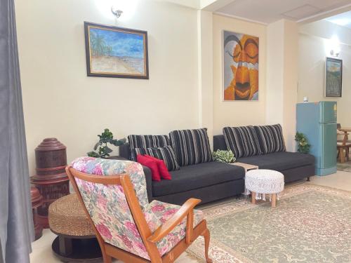 a living room with a couch and a chair at Baan Mali Three in Hua Hin