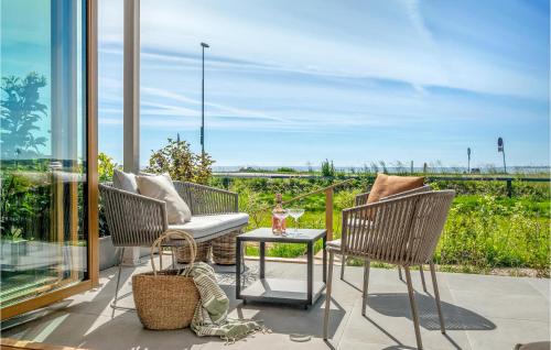 a patio with chairs and a table with a view at Gorgeous Apartment In Kerteminde in Kerteminde